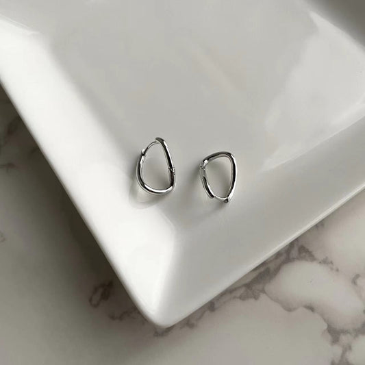 a pair of silver hoop earrings